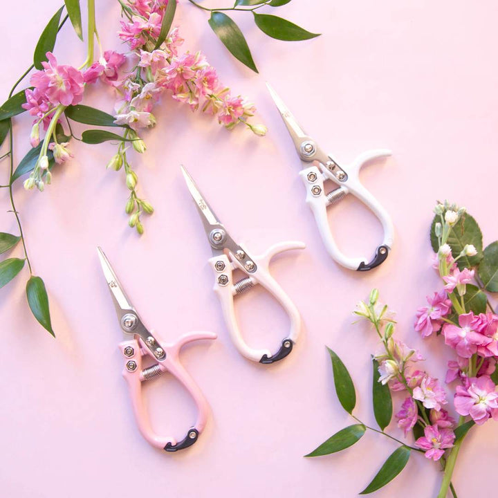Jungle Club | Pruning Shears | All Colors | next to pink flowers.