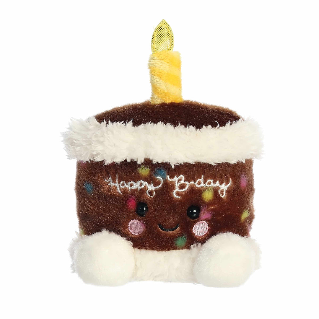 Plush toy shaped like a birthday cake with a candle on a white background