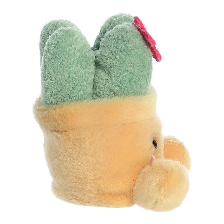 Plush toy cactus with green head and pink bow on a white background