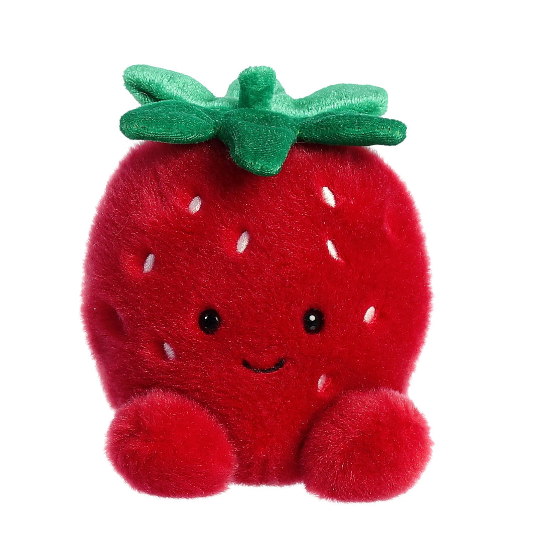 Plush strawberry toy with a smiling face on a white background