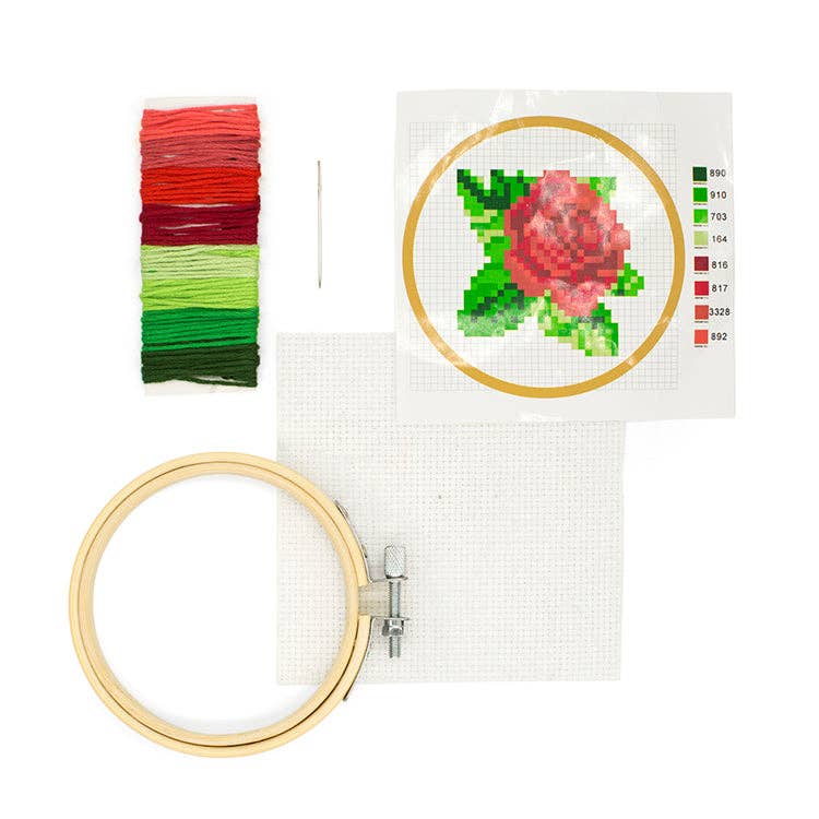 Kikkerland | Rose Embroidery kit with hoop, thread, and cross-stitch pattern on a white background