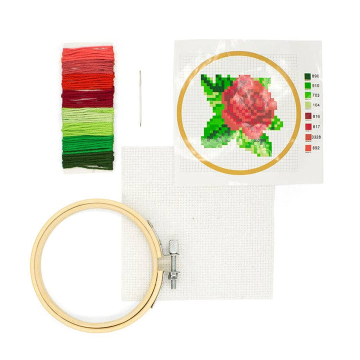 Kikkerland | Rose Embroidery kit with hoop, thread, and cross-stitch pattern on a white background