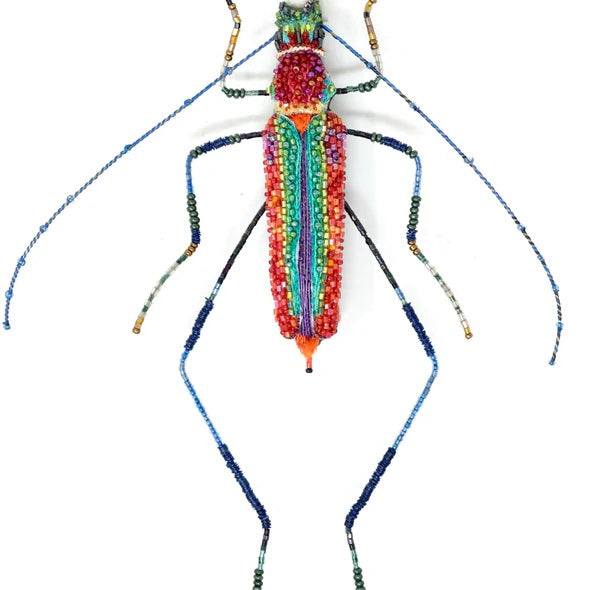 Colorful beaded insect sculpture on a white background