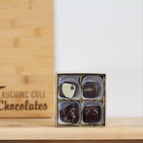 Laughing Gull Chocolates | Rochester Inspired Bites | Four square bite sized chocolates in a box.