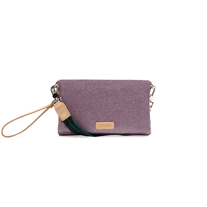 Lyndz Uptown Crossbody | Consuela | A sparkly purple crossbody bag with a leather wrist strap and a green/blue crossbody strap.