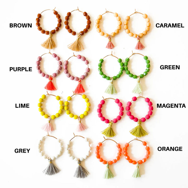Small Gold Hoops with Beads and Tassels | Multiple colors of beaded earrings displayed against a white background. Colors are white/gray, lime/pink, purple/red, brown/caramel, caramel/pink, green/lime, magenta/green, and orange/lime.