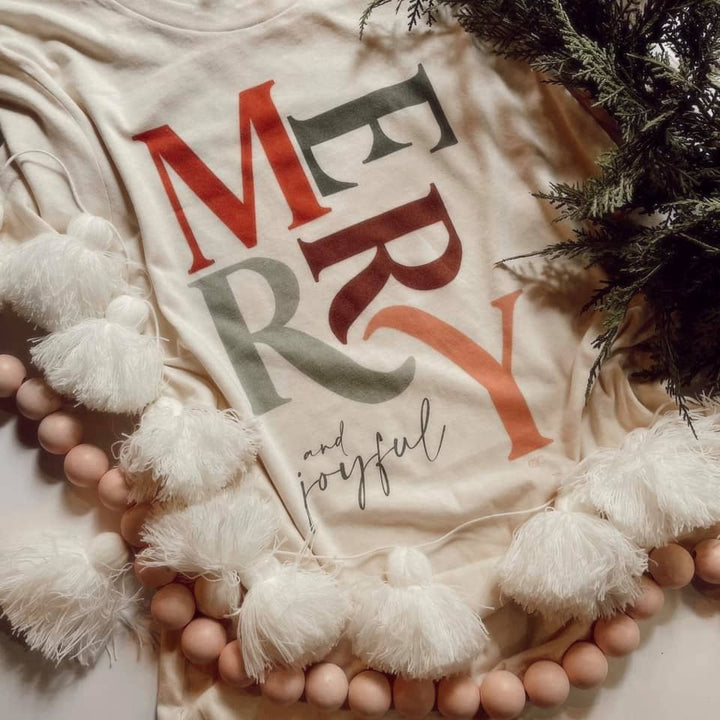 Whitney | Chaudoin Creations | A Cream shirt from comfort colors with text "Merry and Joyful" in a neutral Christmas color palette.