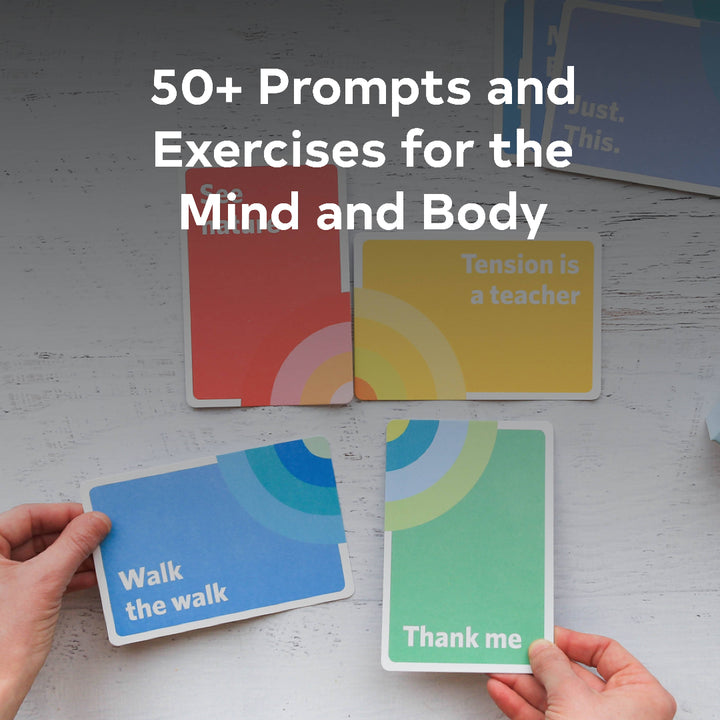 Colorful cards with motivational phrases on a white surface, held by hands.