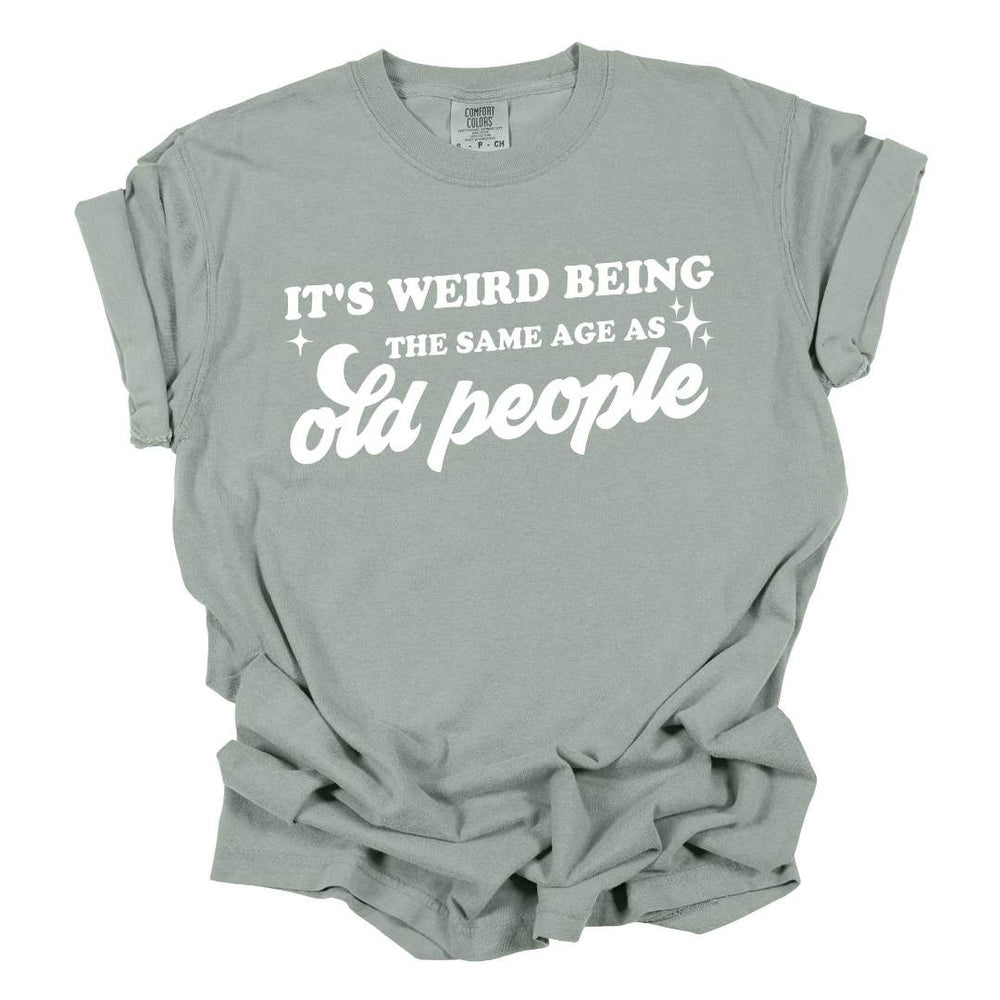 Mugsby | "It's Weird Being The Same Age As Old People" T-Shirt | Comfort Colors, 100% Cotton. Sage Green