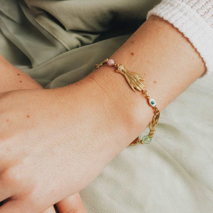 Adjustable Pastel and Flower Charm Bracelet for Spring | Nest Pretty Things | Gold bracelet with charms and beads. Accented with pink and green.