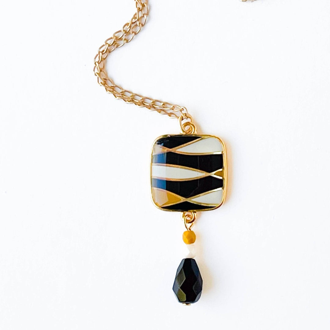 Nest Pretty Things | Mid-Century Pendant Necklace Assorted | Close up on the black/white/gold pendant.