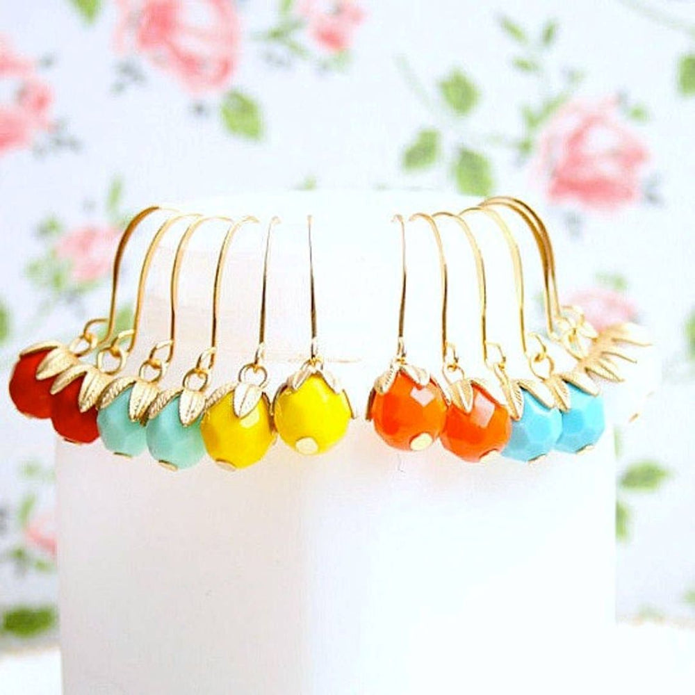 Nest Pretty Things | Colorful beaded earrings on gold hooks with a floral background