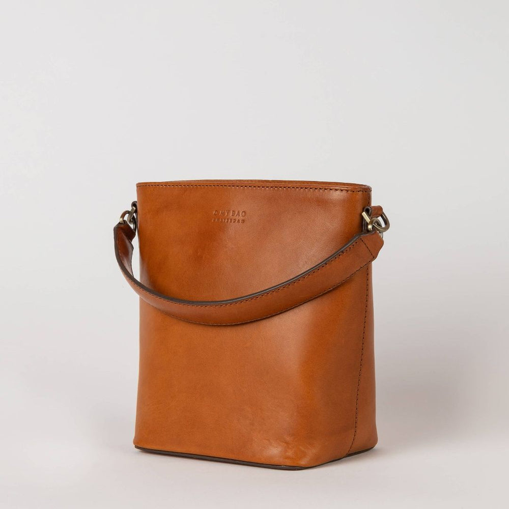 O My Bag | Bobby Bucket | Cognac Leather | Brown leather handbag on a light gray background
