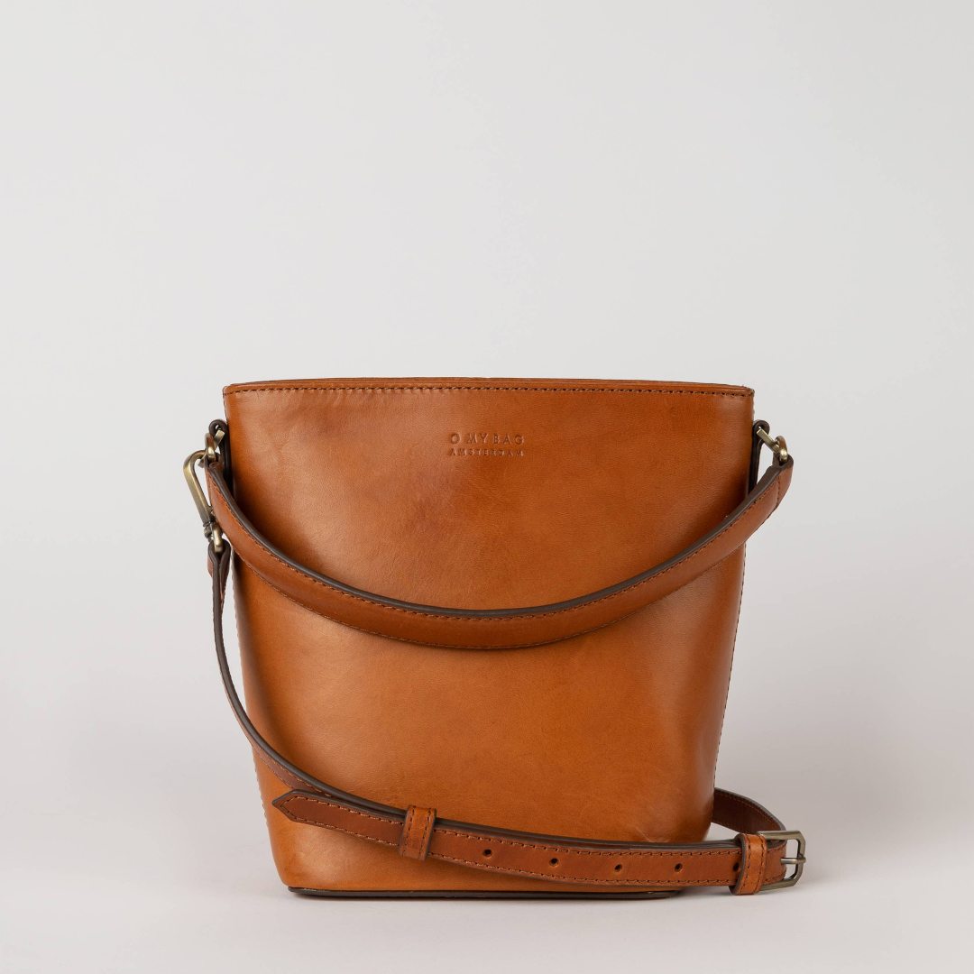 O My Bag | Bobby Bucket | Cognac Leather | Brown leather handbag on a light gray background