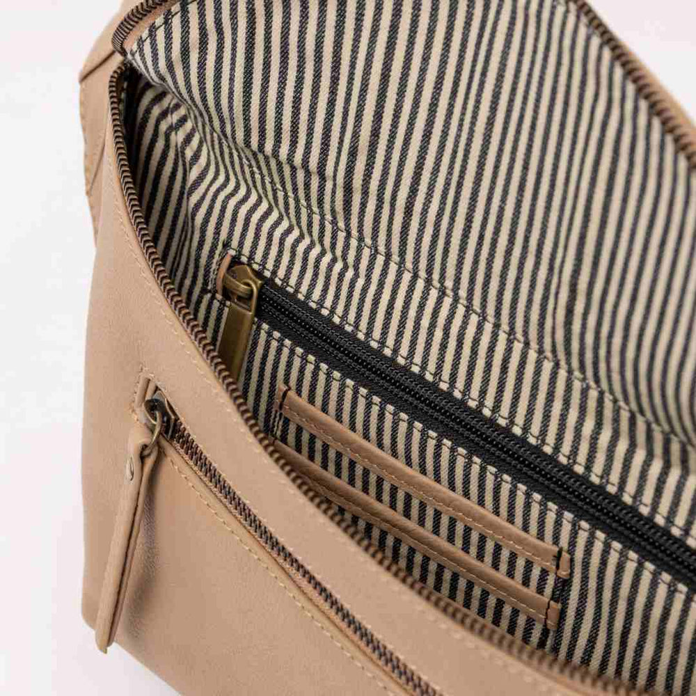 O My Bag | Drew Bum Bag | Close-up of a beige bag with striped lining on a white background