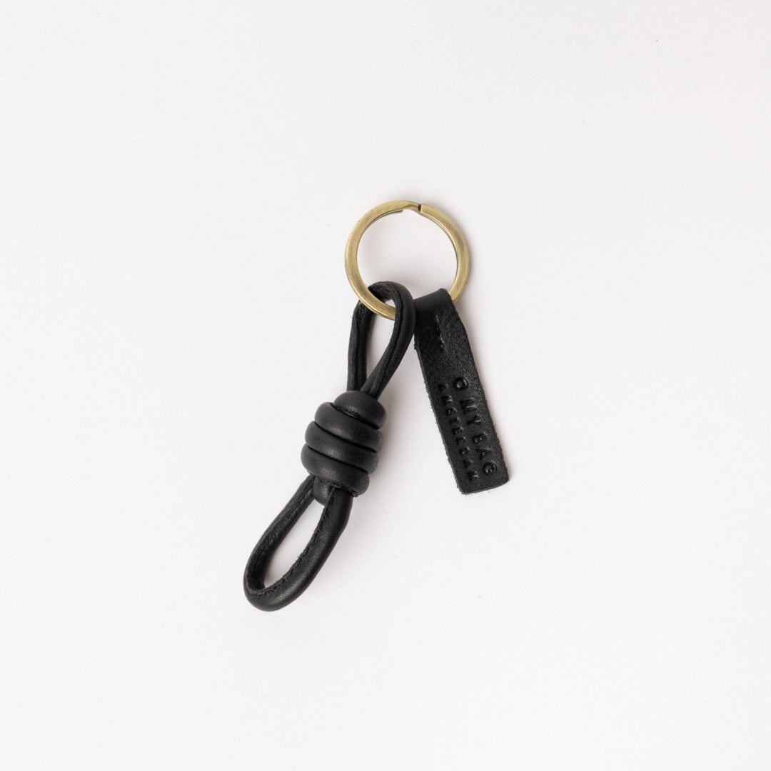 O My Bag | Leather Keychain | Black leather keychain with gold ring on a white background
