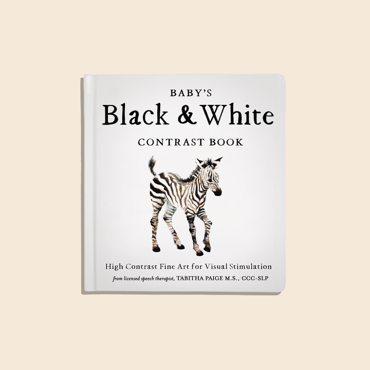 Book titled 'Baby's Black & White Contrast Book' with a zebra illustration on a beige background
