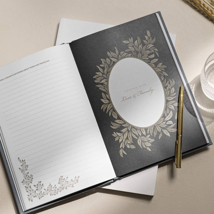 Open notebook with decorative cover and pen on a light surface