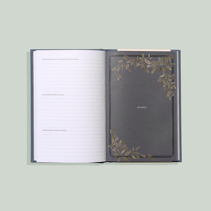 Open notebook with decorative cover on a light green background