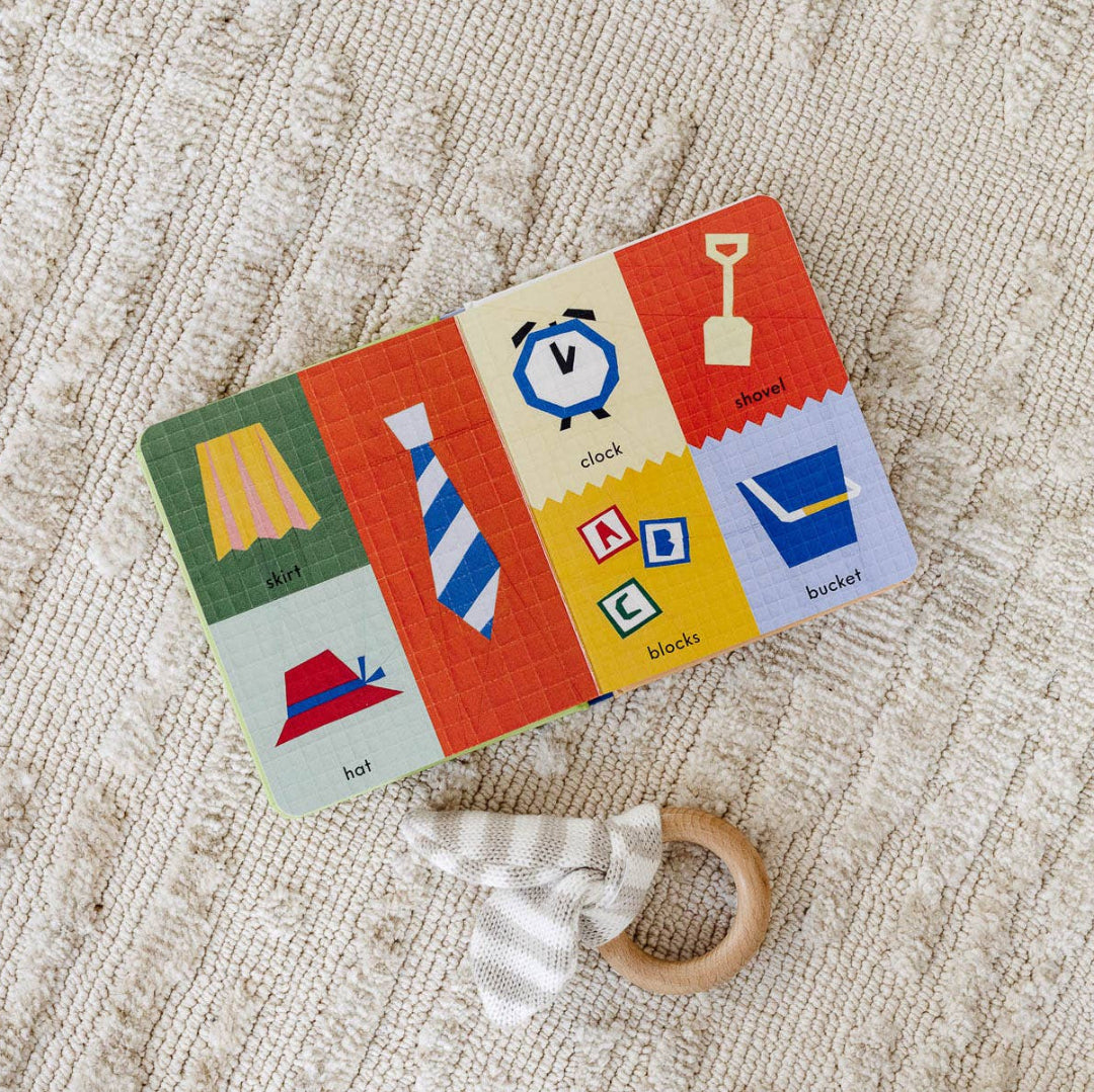 Colorful children's card with illustrations of objects on a textured beige surface