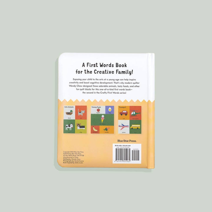 Back cover of a book titled 'A First Words Book for the Creative Family' on a gray background