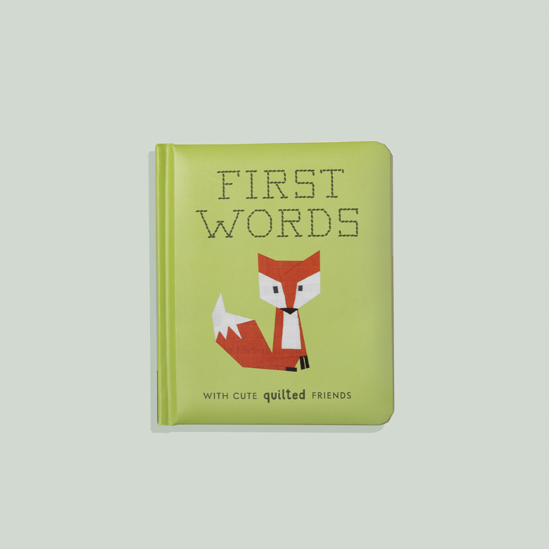 Children's book titled 'First Words' with a fox illustration on a light gray background
