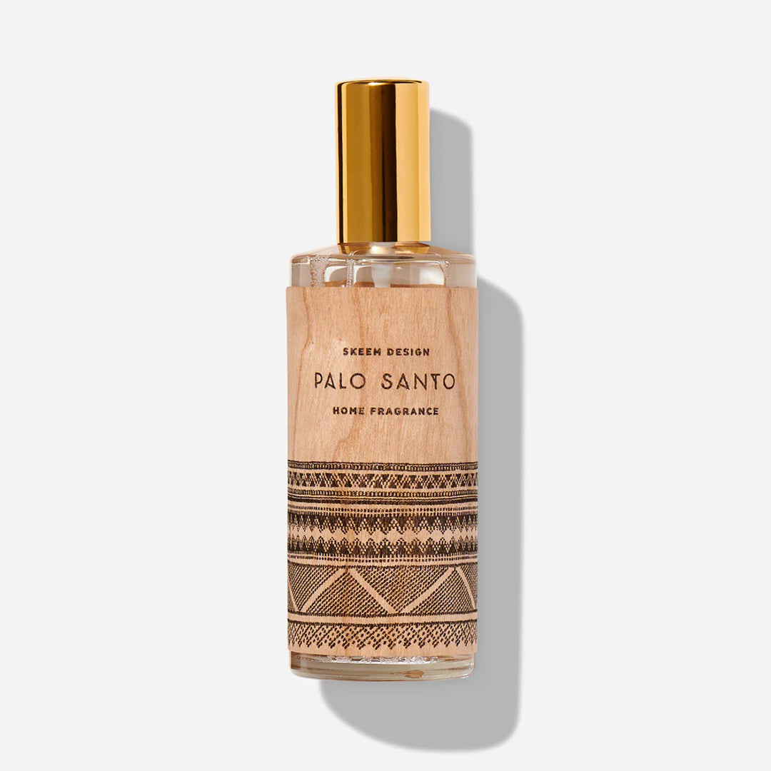Palo Santo Home Fragrance | A spray bottle with a wooden label that has a geometric pattern. Text reads "Skeem Design. Palo Santo, Home Fragrance".