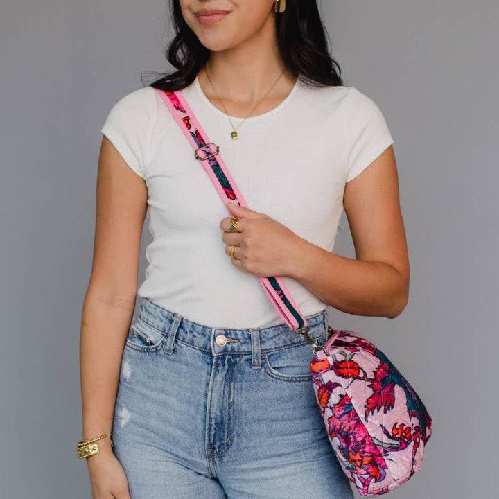 Panache Apparel Co. | Woman holding a colorful pink floral bag with a gray background