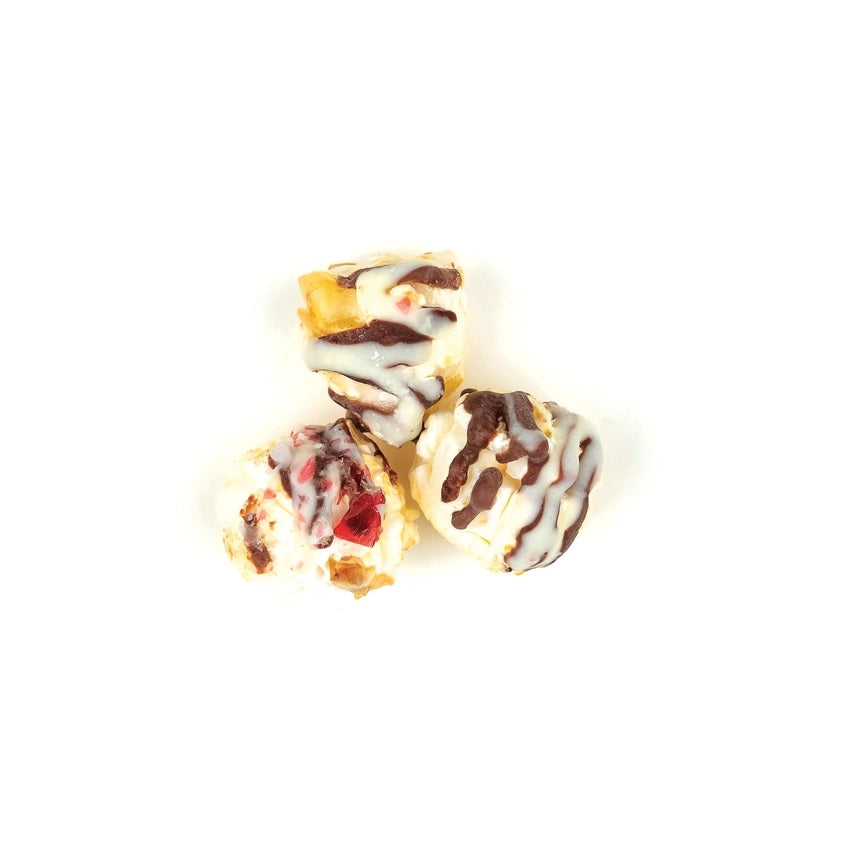 Three small, round, dessert-like items with different toppings on a white background