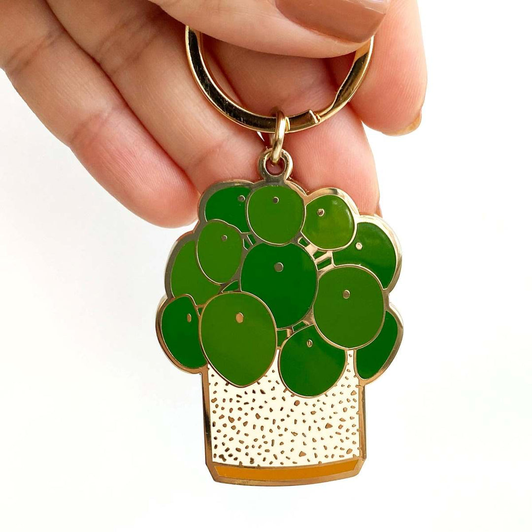 Pilea Plant Keychain | A green enamel pilea plant in a pot.