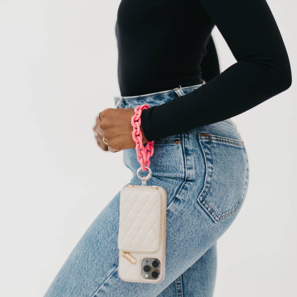 A bright pink acrylic chain wristlet attached to a phone.