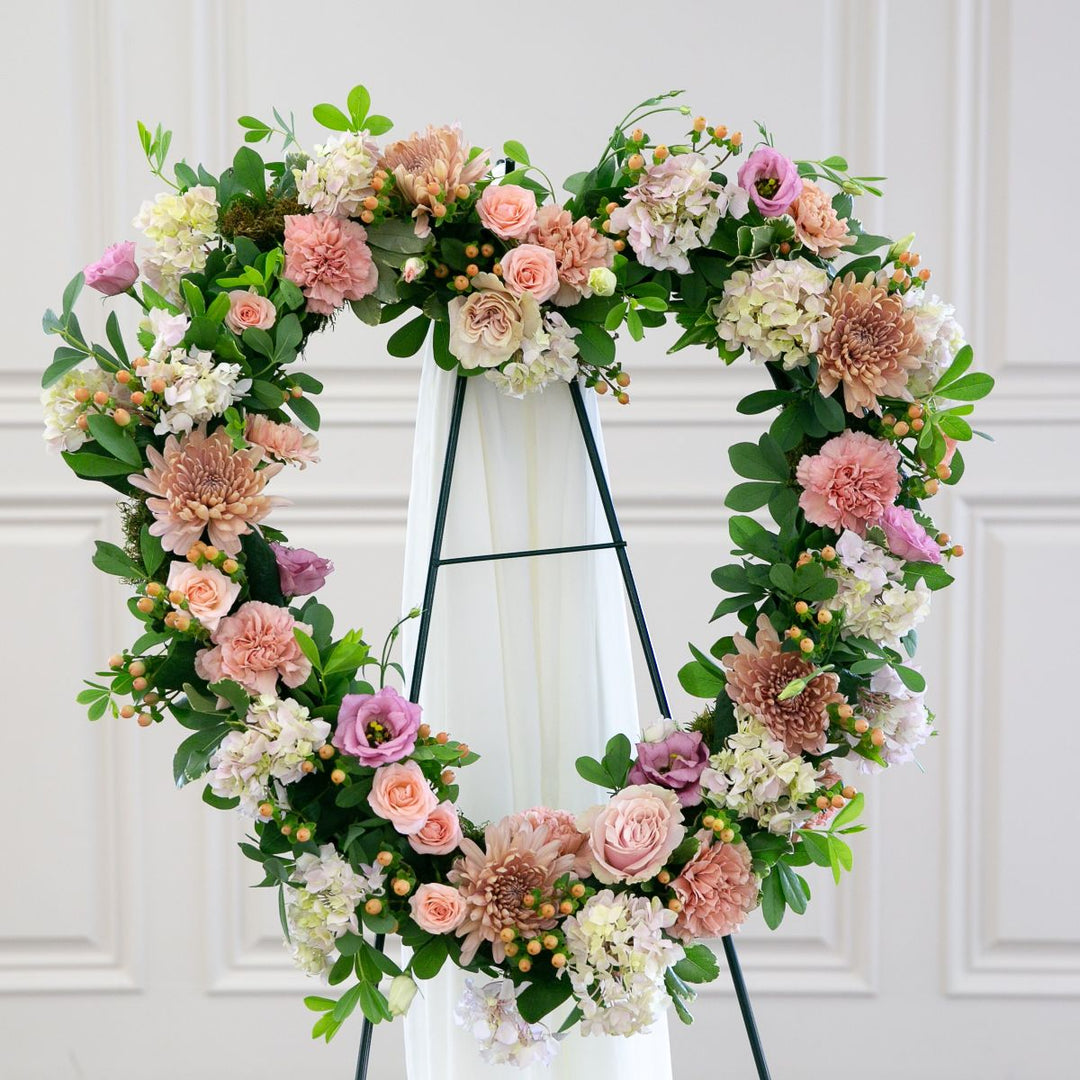 Floral arch with pink, white, and green flowers on a white background