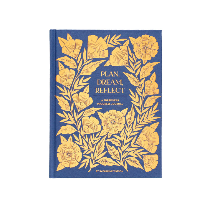 Blue journal with gold floral design and text on a white background