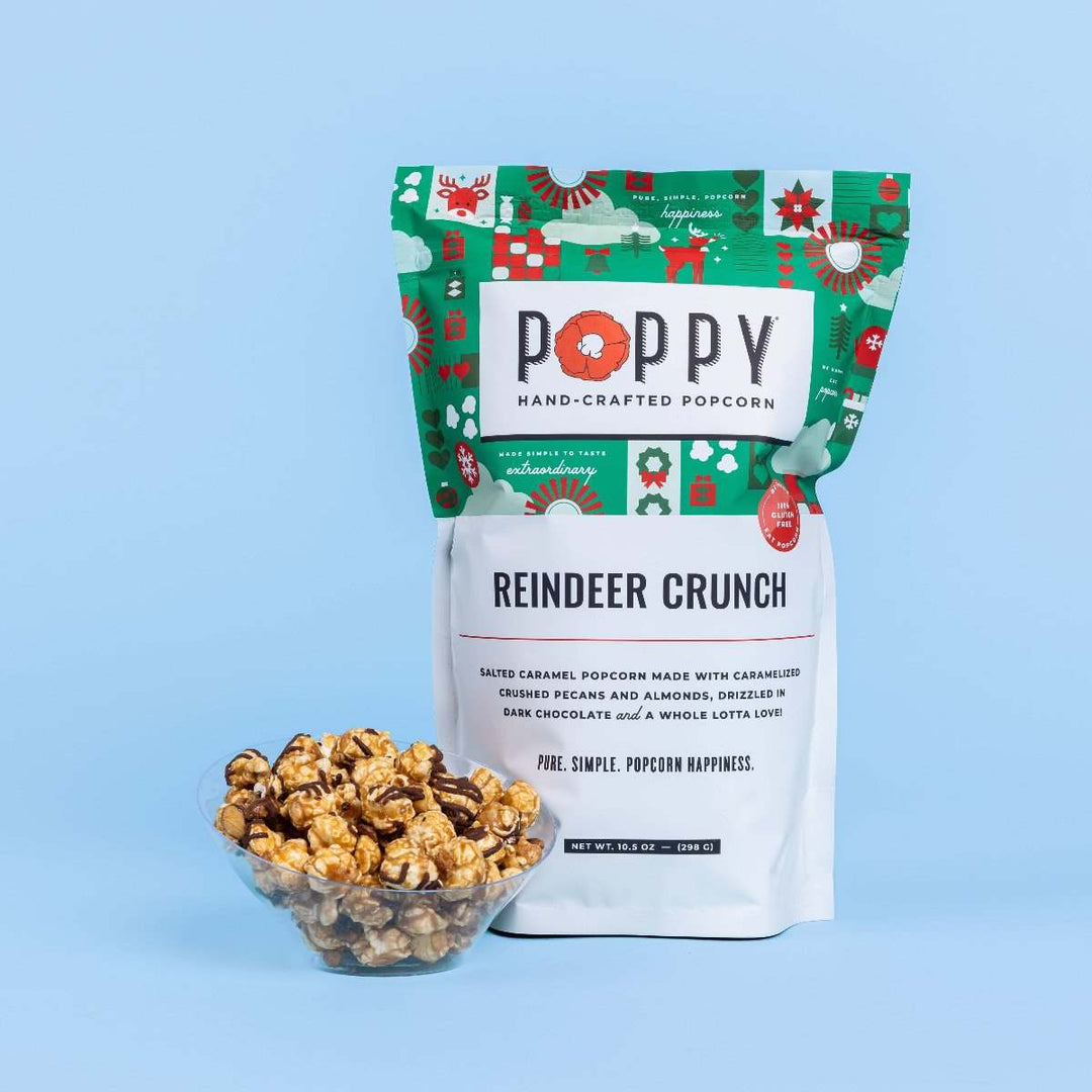 Poppy Hand-Crafted Popcorn | Reindeer Crunch Popcorn | A holidaythemed bag with a small bowl of popcorn placed next to it.