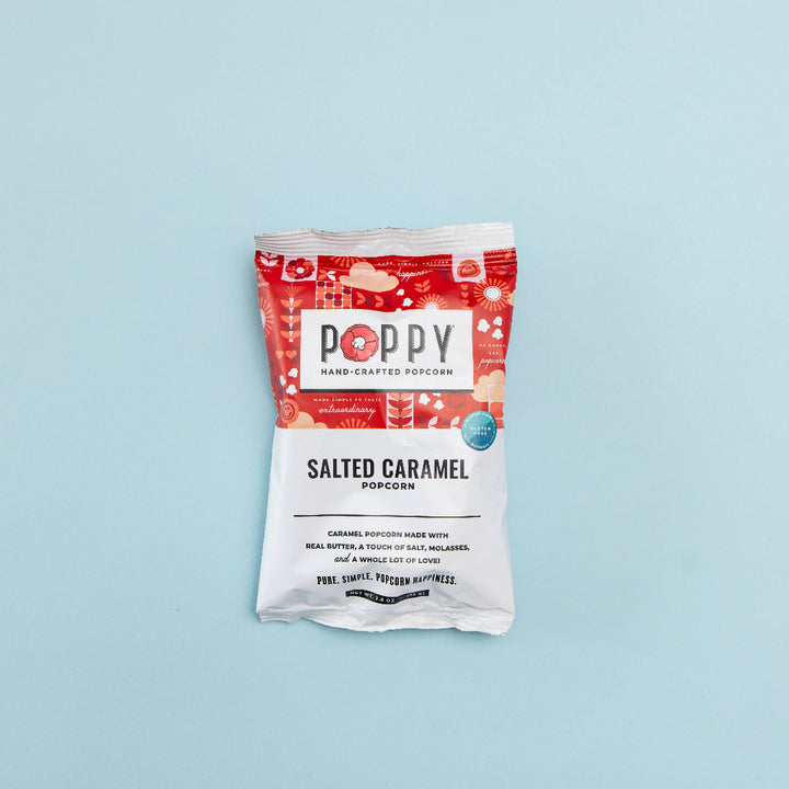 Poppy salted caramel popcorn package on a light blue background