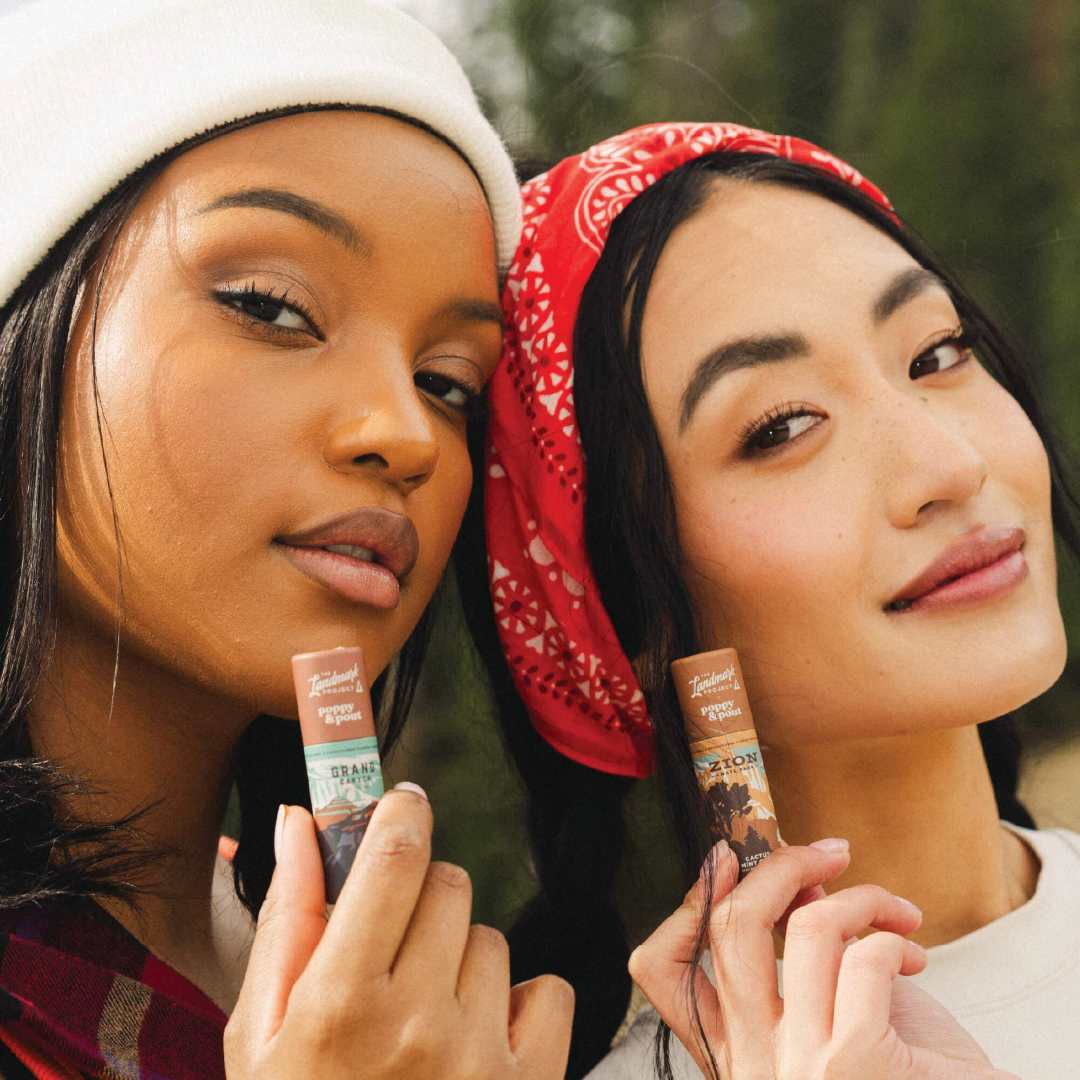 Poppy & Pout | the landscape project, grand canyon lip balm and zion lip balm held by models.