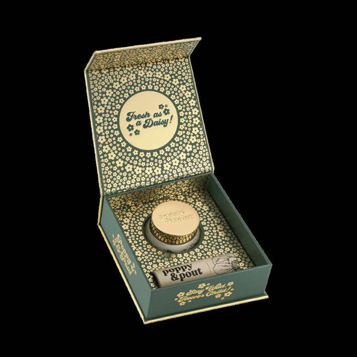 Lip Care Duo, Island Coconut | Poppy & Pout | Box interior showing the green and gold daisy accented package with the lip scrub and lip balm.