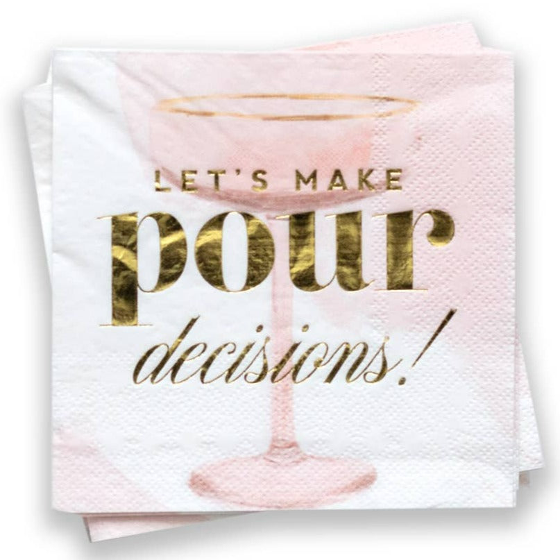 A pink and white napkin with a cocktail glass in the background. Gold foiled text reads "Let's make pour decisions!".