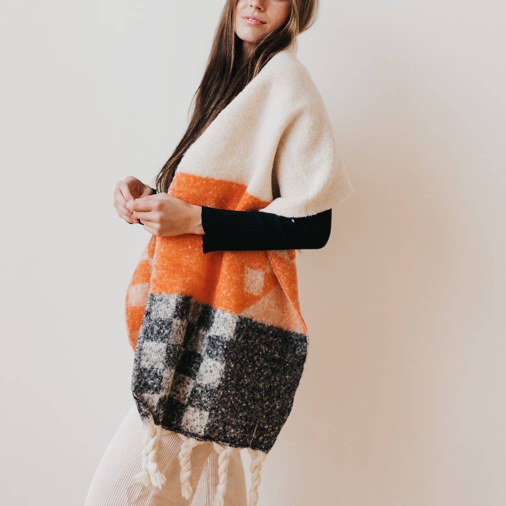 Pretty Simple | Autumn Spice Checkered Scarf | A white, orange, and dark gray scarf/shawl on a model for scale.