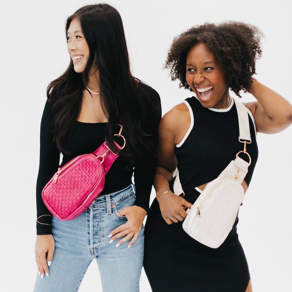 Two models posing with their woven vegan leather bags. One is pink, the other is cream.