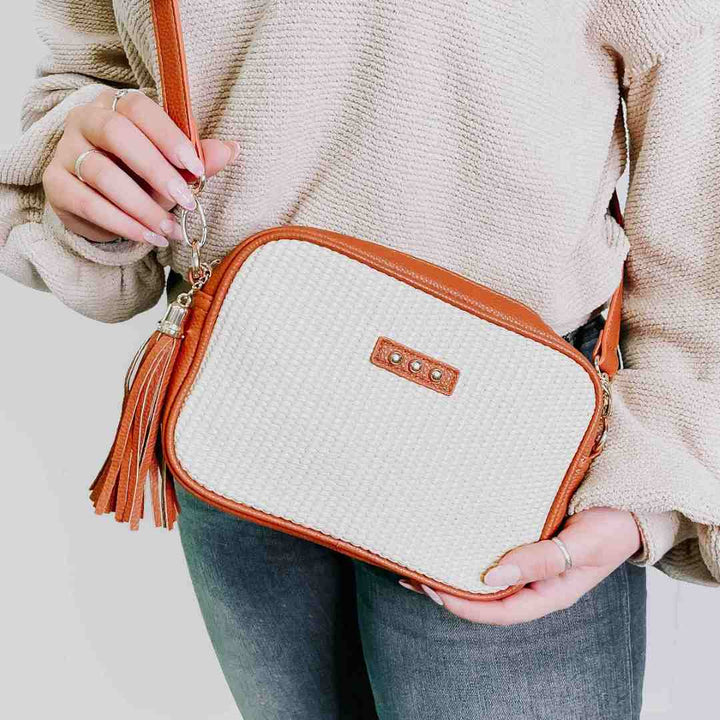 A brown accented basket bag with white.