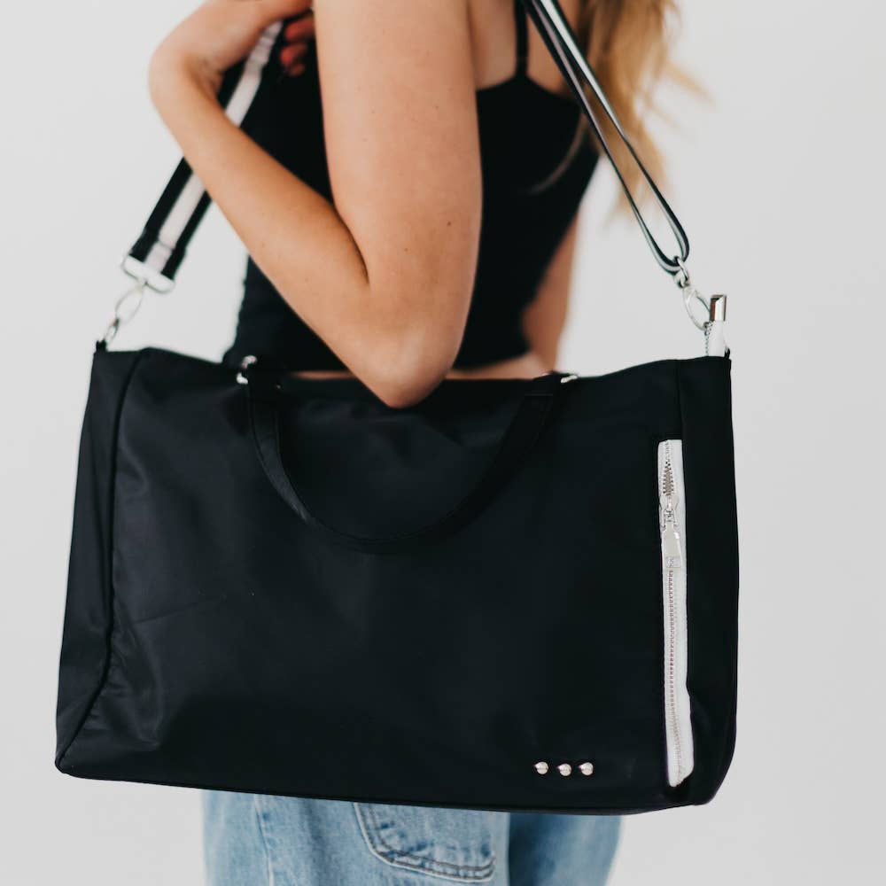 Pretty Simple | Nina Nylon Tote | Black Close up on a white zipper and identifying "pretty simple" 3 silver dots.