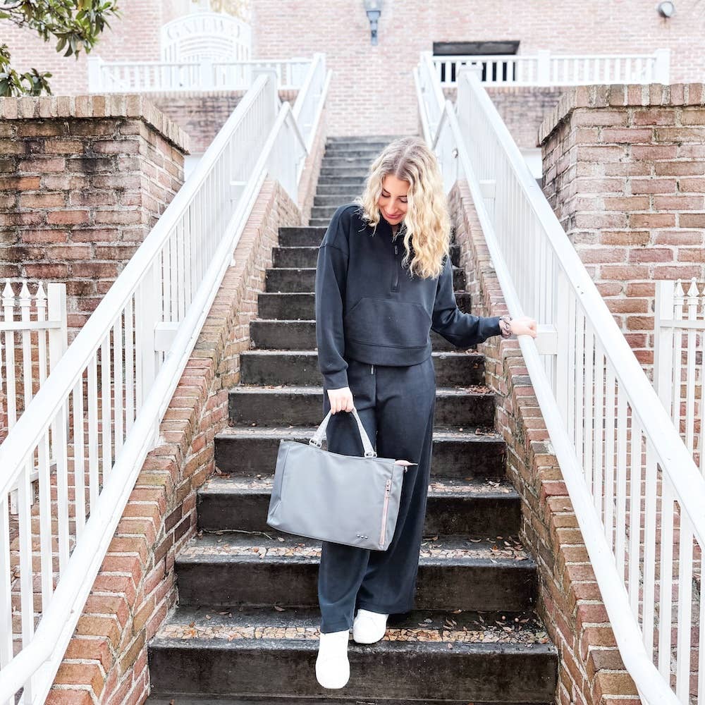 Pretty Simple | Nina Nylon Tote | Model with a gray tote with pink accents.
