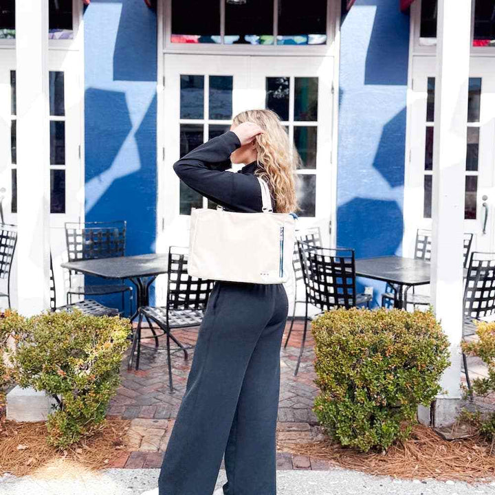 Pretty Simple | Nina Nylon Tote | Cream tote displayed on a model.