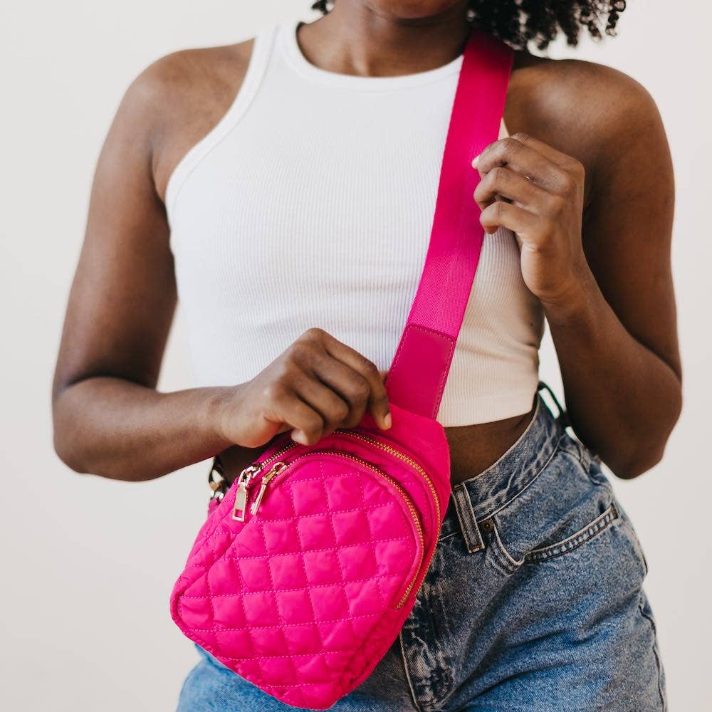 A bright fuchsia crossbody bag with a quilted design.