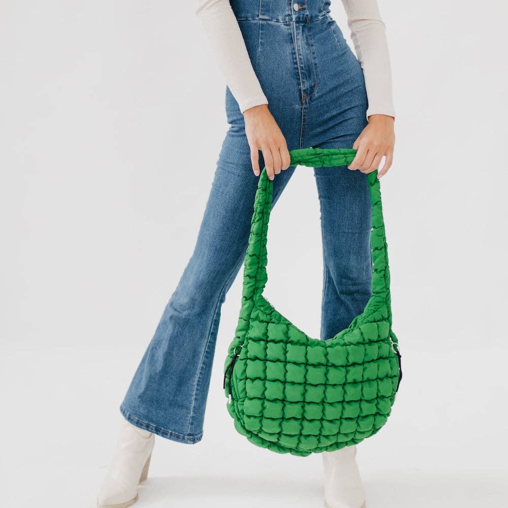 Pretty Simple | Carmen Quilted Hobo Tote Bag: Emerald | A quilted green bag with an attached quilted handle. Held by a model for scale.