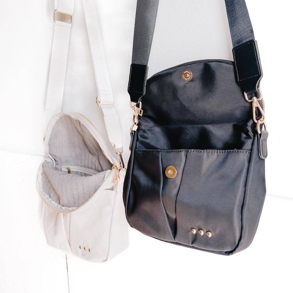 Pretty Simple | Tilly Crossbody Bag | Black and white, both with gold hardware. Detail shot of the interior.