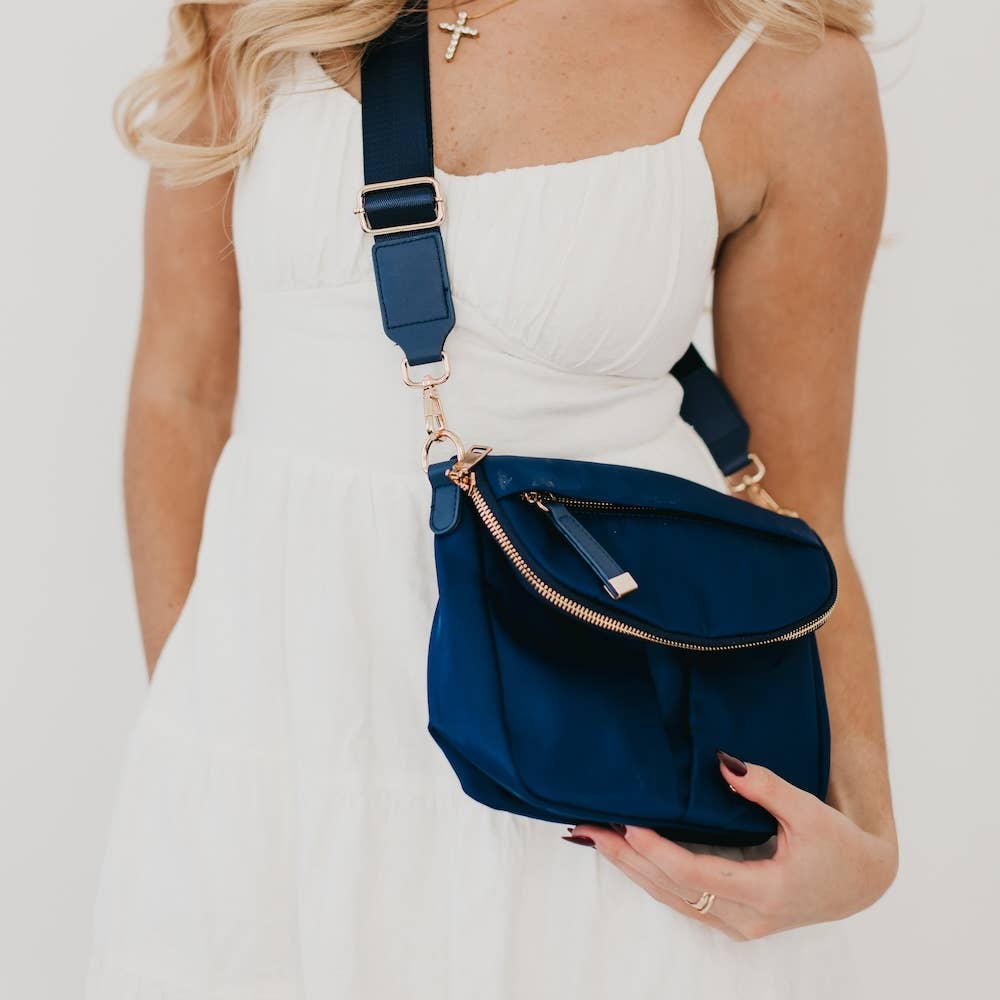 Pretty Simple | Tilly Crossbody Bag | Navy with gold accents, on a model wearing white.