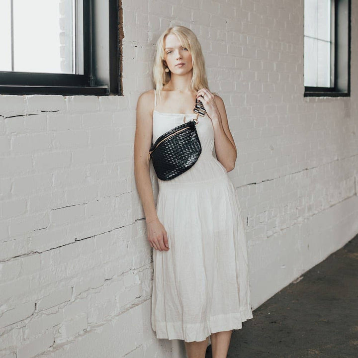 Pretty Simple | Westlyn Woven Bum Bag | Black crossbody bag against a white dress.
