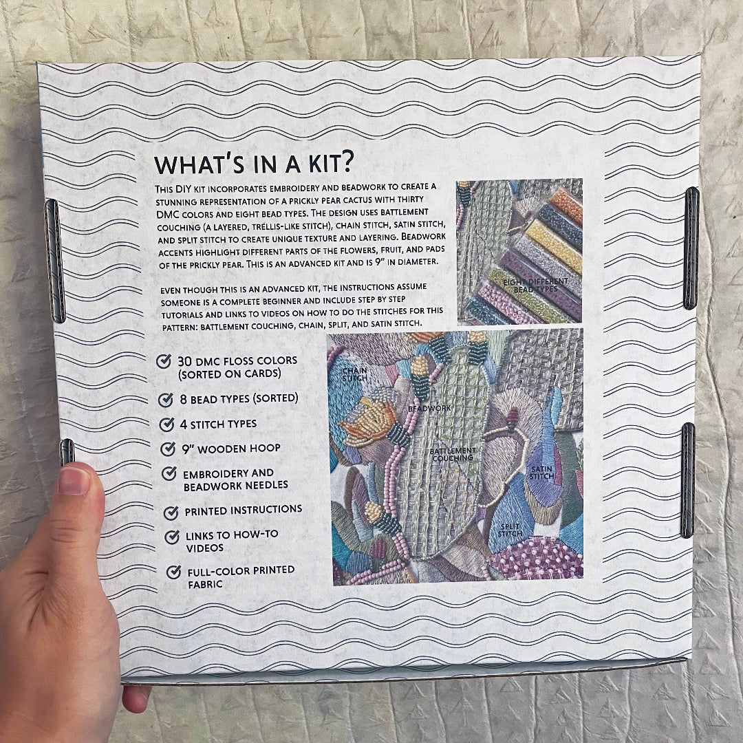 Kit information sheet with embroidery design on a textured surface